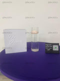 May include: A white square box with the embossed text The Grants, a clear cylindrical glass vase containing water and a floating light pink candle, and a small black rectangular sign with white text and a green QR code icon.